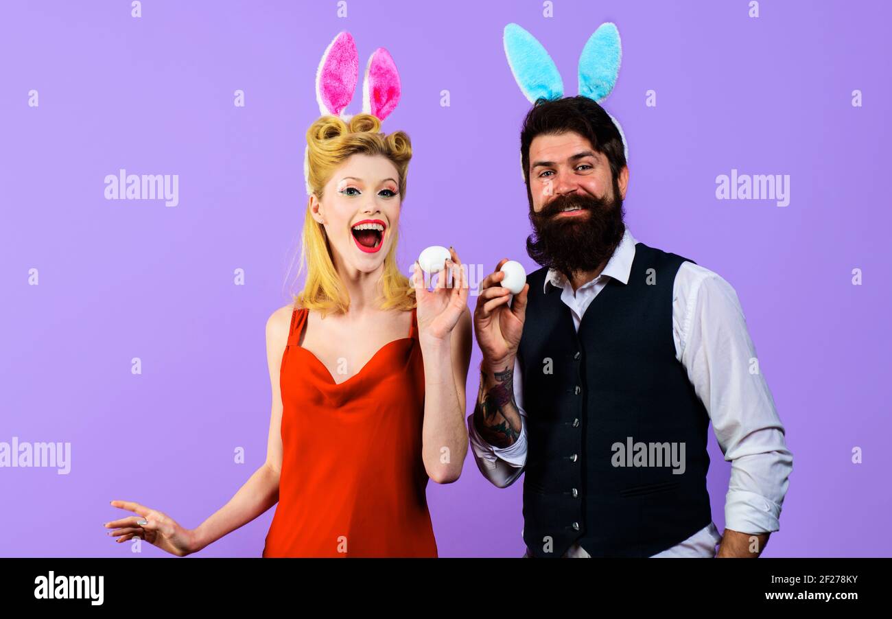Happy couple with bunny ears with white eggs for Easter. Funny family. Spring holidays. Stock Photo
