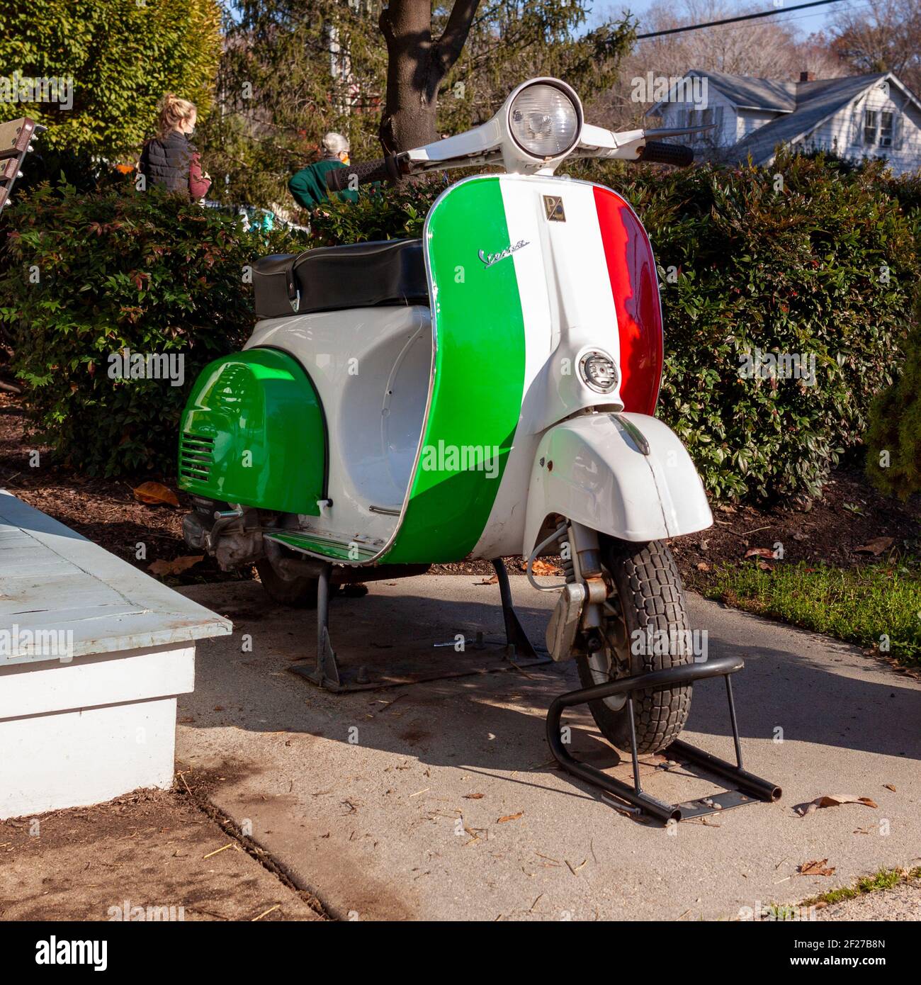 Clifton, VA, USA 11-14-2020: A Vespa scooter motorbike painted in the striped colors of Italian Flag (green, white and red) produced by Italian Piaggi Stock Photo