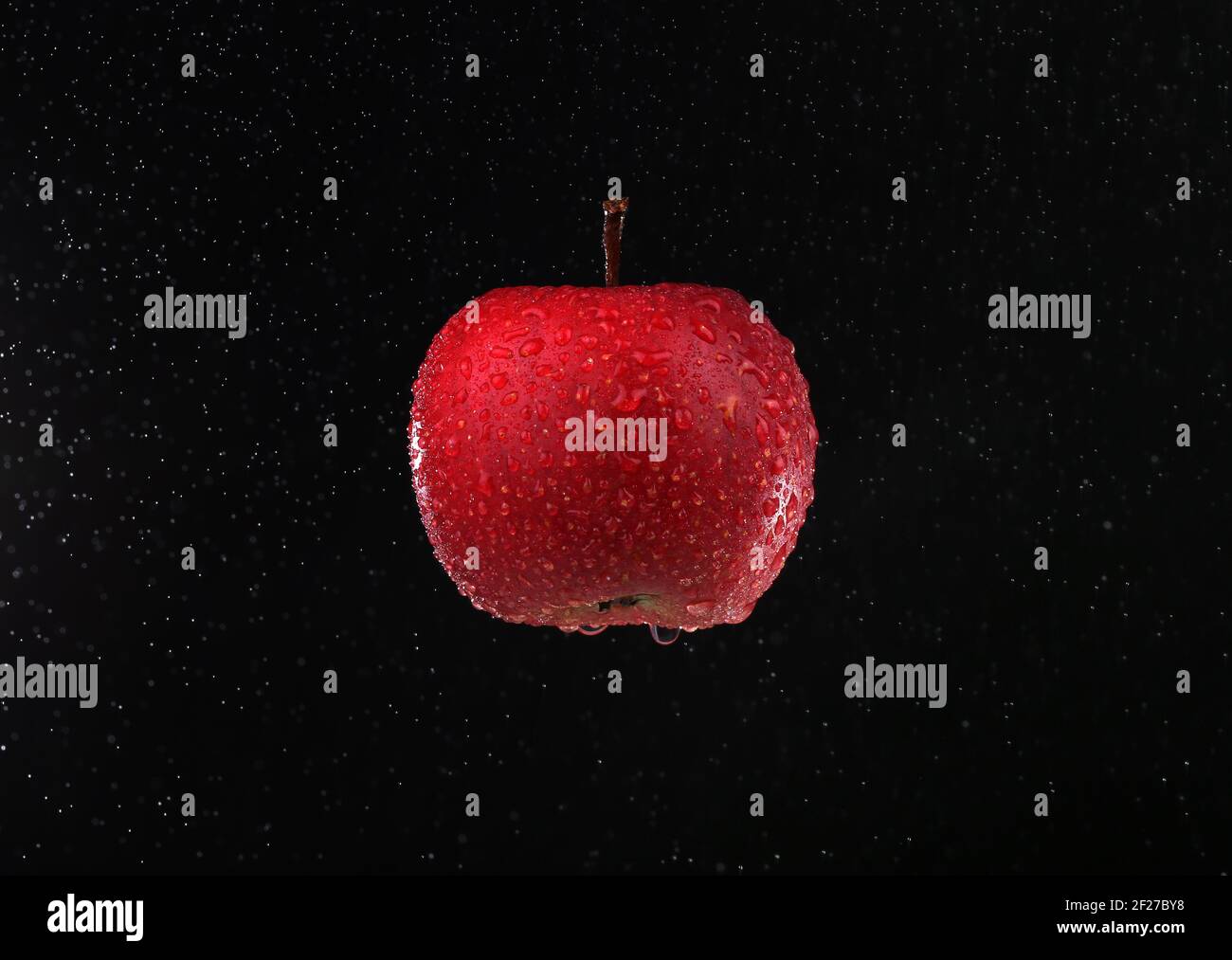 Delicious juicy red apple on a black background for everyone who likes
