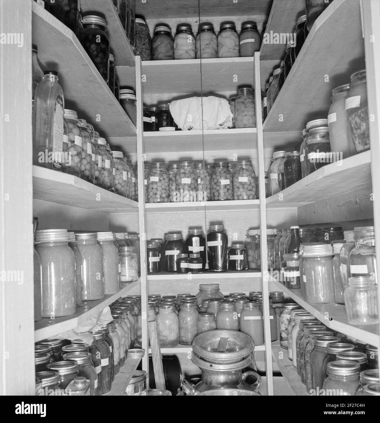 Mrs. Granger's storeroom. She has 500-600 quarts of canned food. 'You never know what may happen.' Yamhill farms. (FSA - Farm Security Administration). Yamhill County, Williamette Valley, Oregon . October 1939 . Photograph by Dorothea Lange Stock Photo