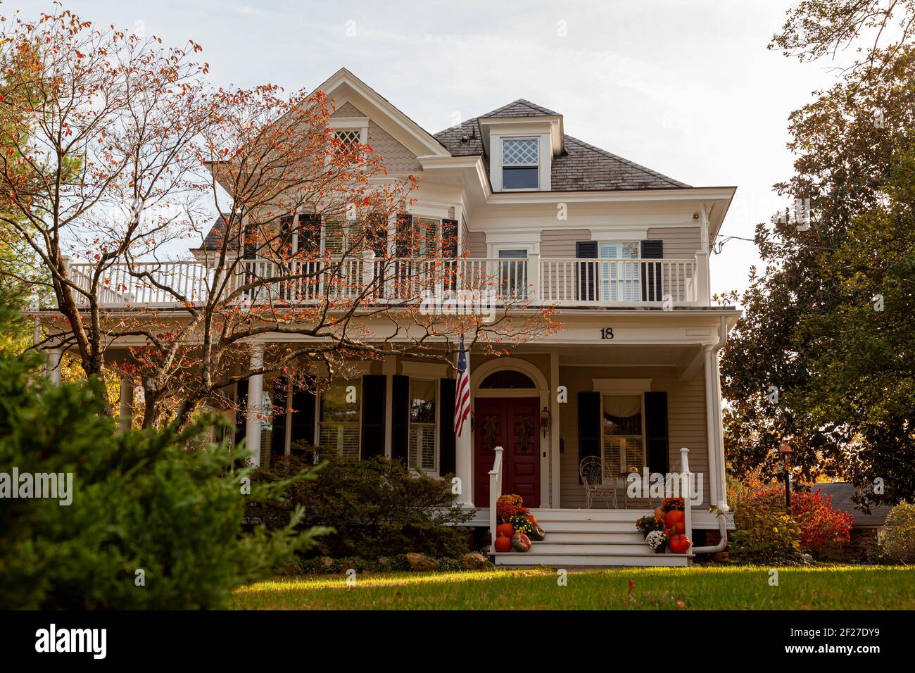 Rockville, MD, USA 11-01-2020: A two story wooden colonial era historic house in a well maintained garden in the historic district of Rockville. There Stock Photo