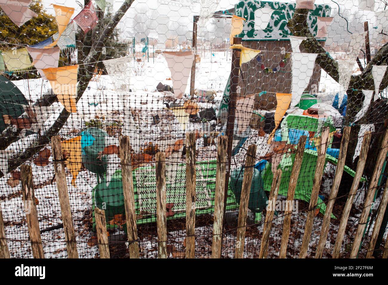 Eclectic fence and decoration in a New England community garden in the winter. Stock Photo