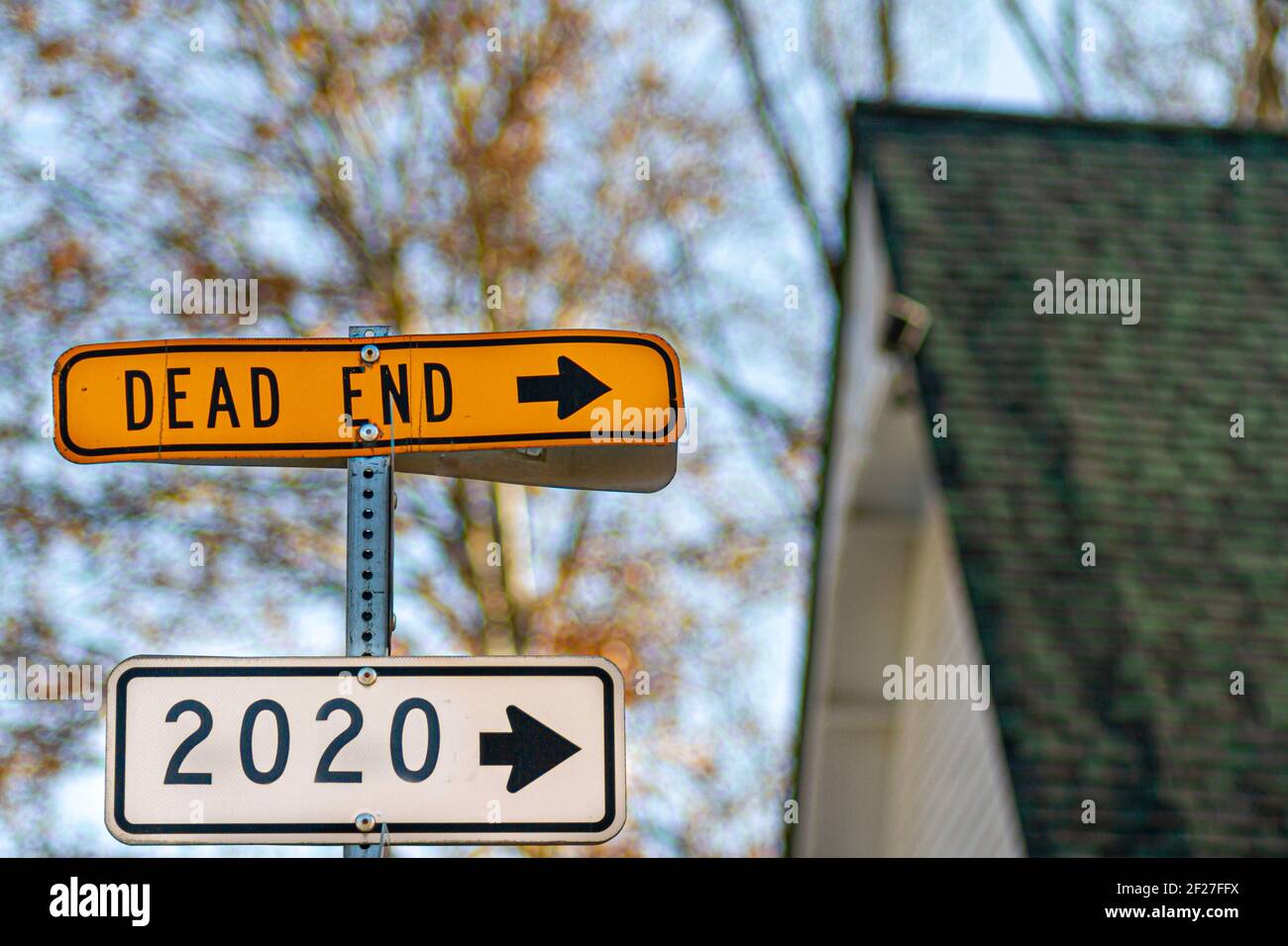 An abstract sarcastic look at the year 2020. Sign post with arrows showing 2020 and 'Dead End' towards the same direction. A concept summary of all un Stock Photo