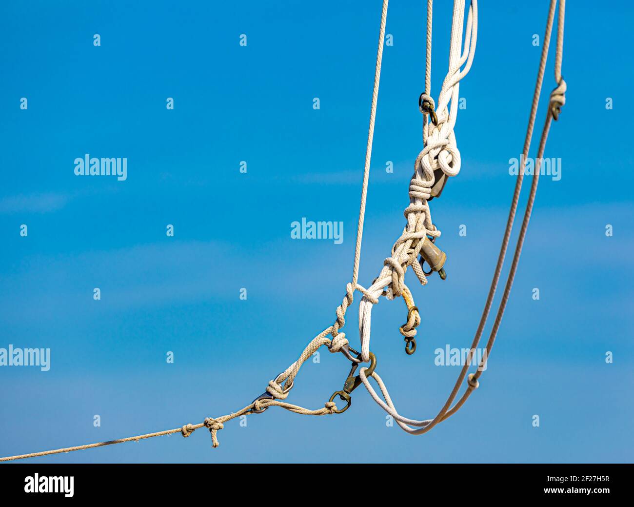 Tangled rope with a brilliant blue sky behind Stock Photo