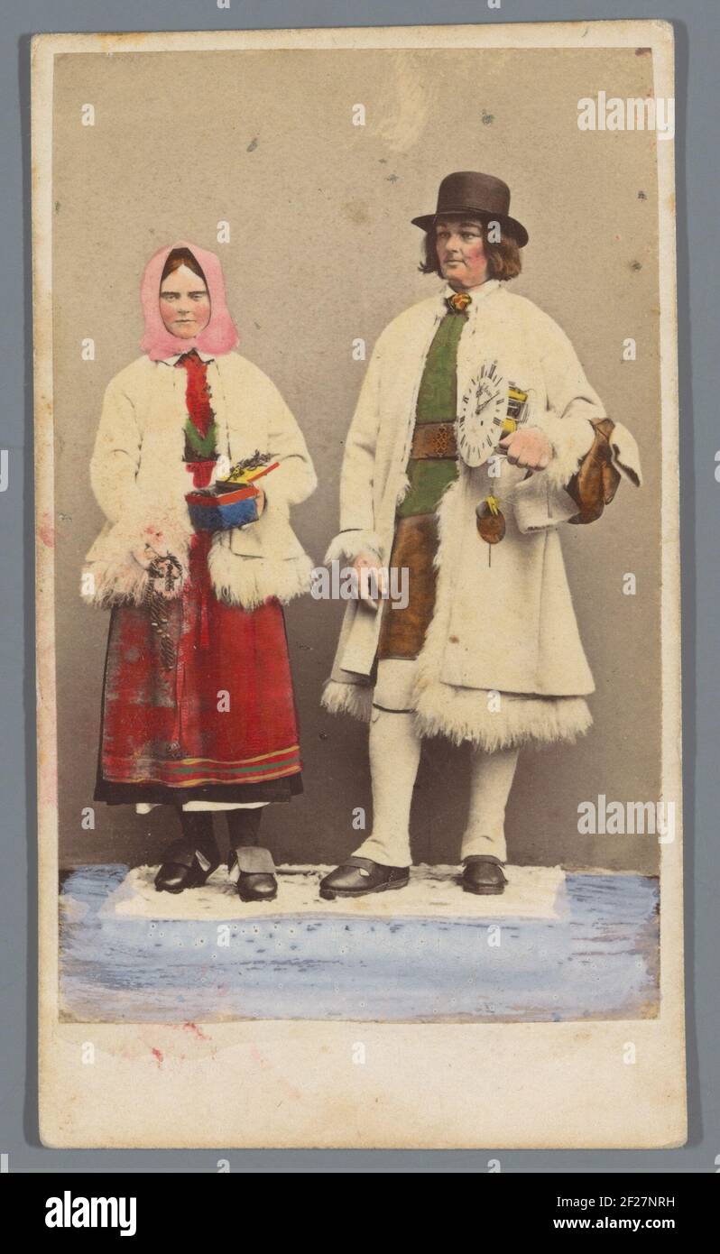 Portrait man with clock and woman with box in traditional darcaslien costume [ON], Sweden .. Stock Photo