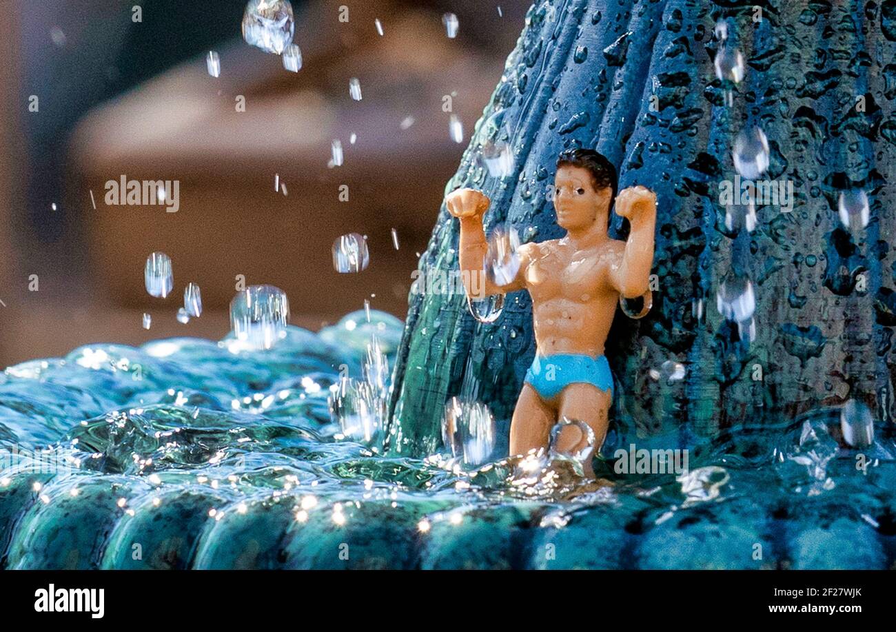 Nigel the he-man enjoys the fine weather soaking under the waterfall Stock Photo