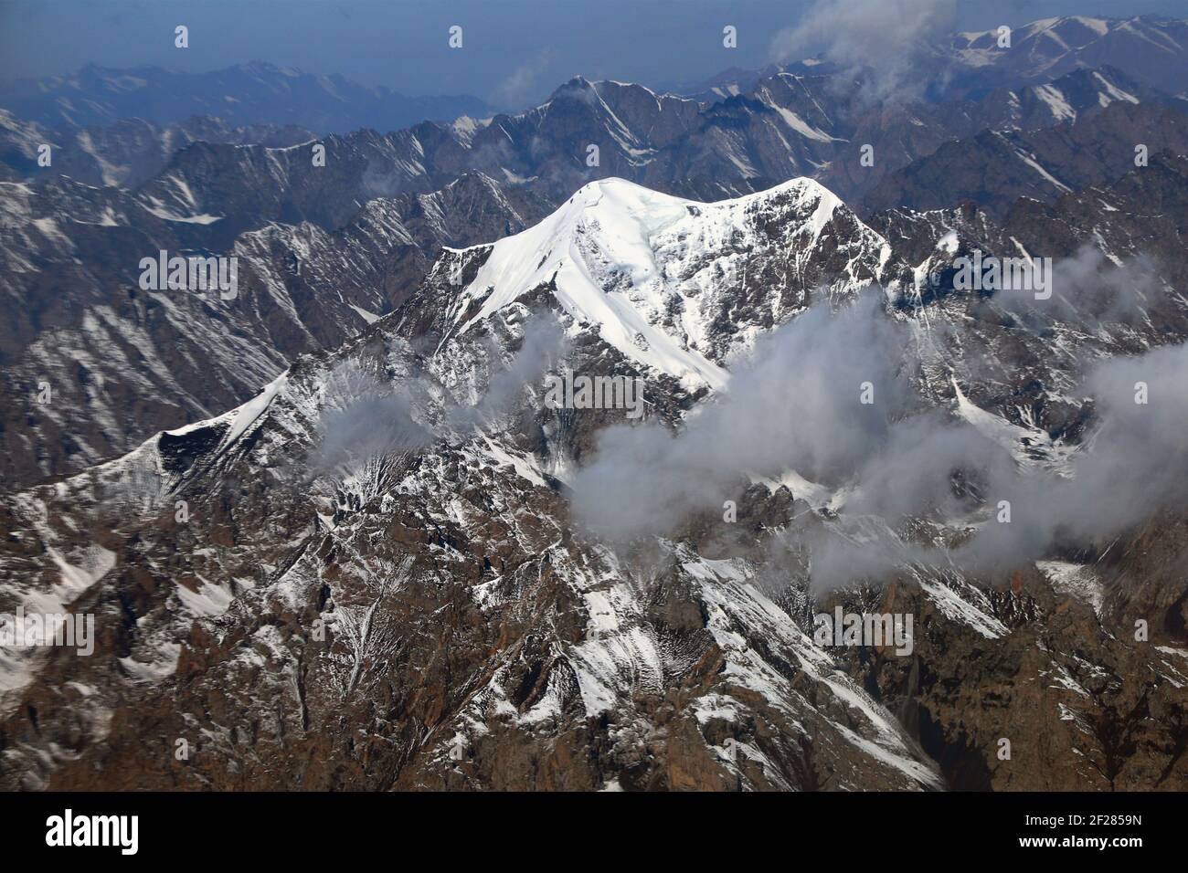 Photo taken from a plane shows the snow covered, undulating Tian Shan ...
