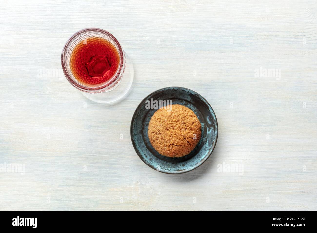 A photo of a glass of sweet wine with a cookie, shot from the top Stock Photo