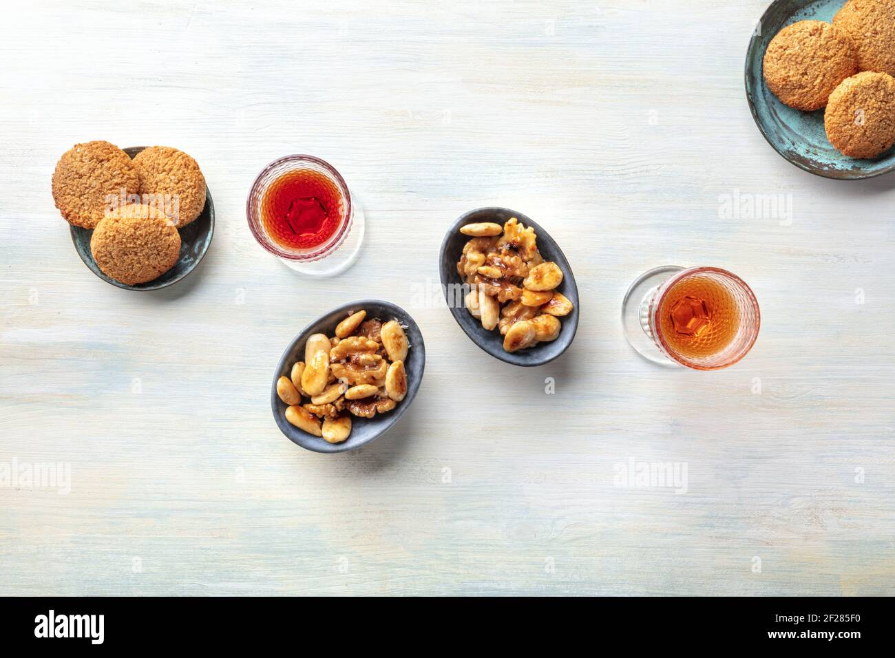 Two glasses of fortified wine with cookies and nuts, shot from above Stock Photo