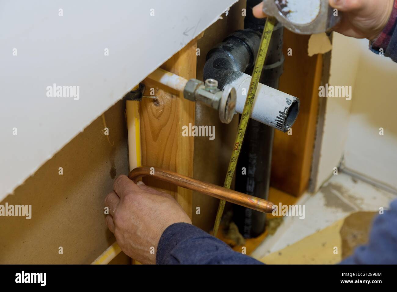 Maintenance plumber service home bathroom in repair of plastic polypropylene water pipes in hole