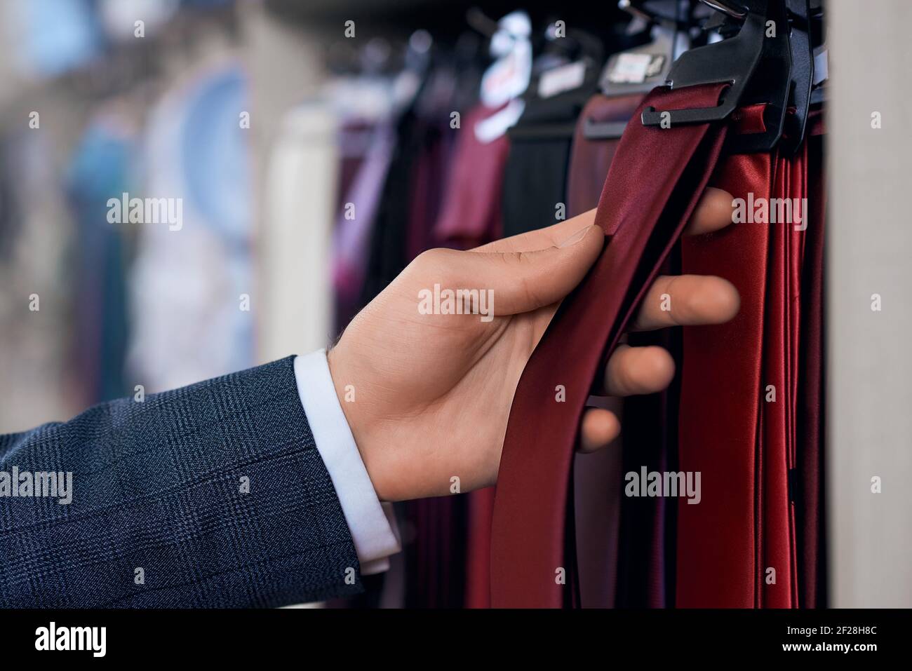 Man's hand holding clothes hi-res stock photography and images - Alamy
