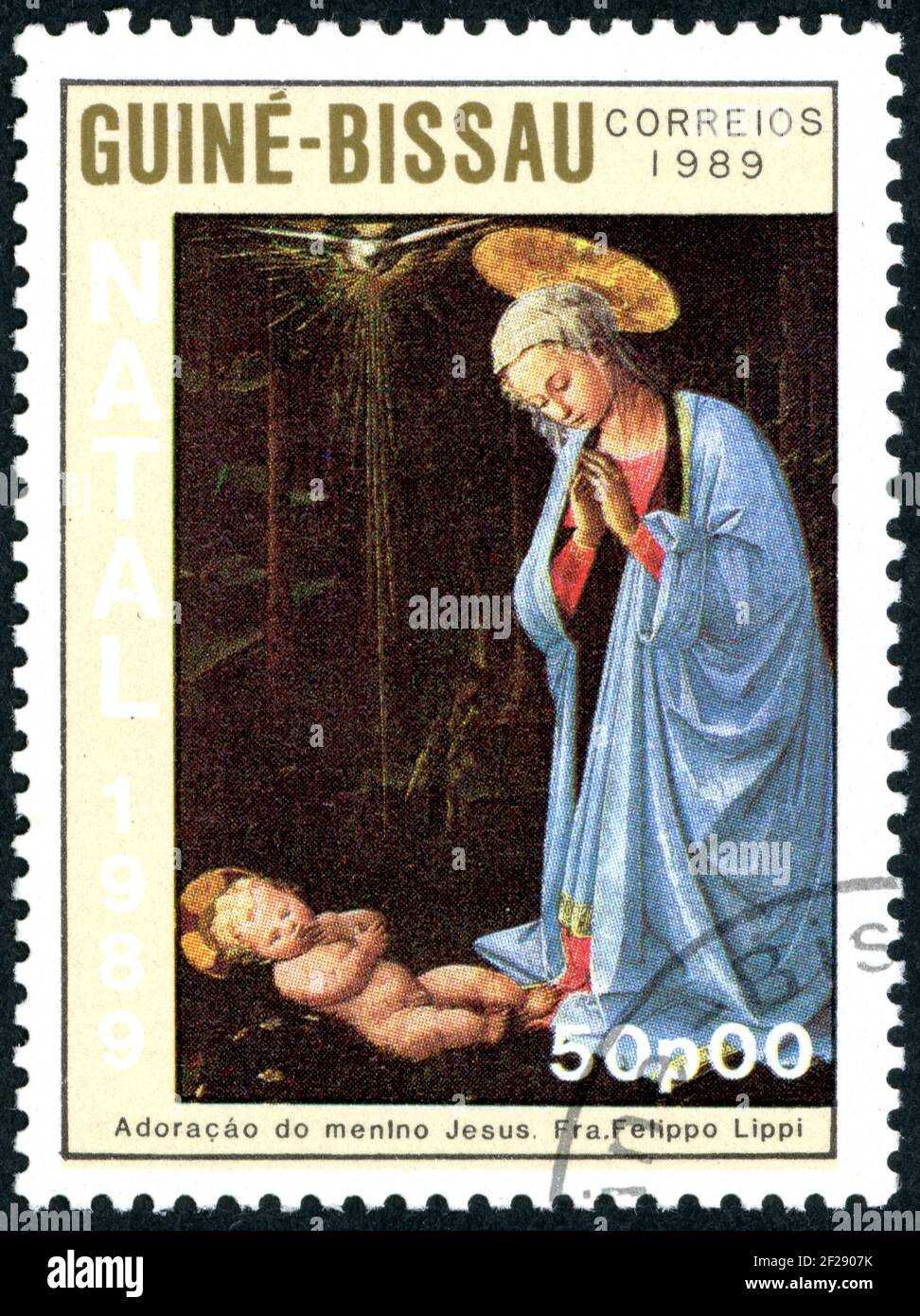 A stamp printed in Guinea-Bissau, shown the painting by Fra Filippo Lippi - Madonna and Child and the Adoration of the Magi, circa 1989 Stock Photo