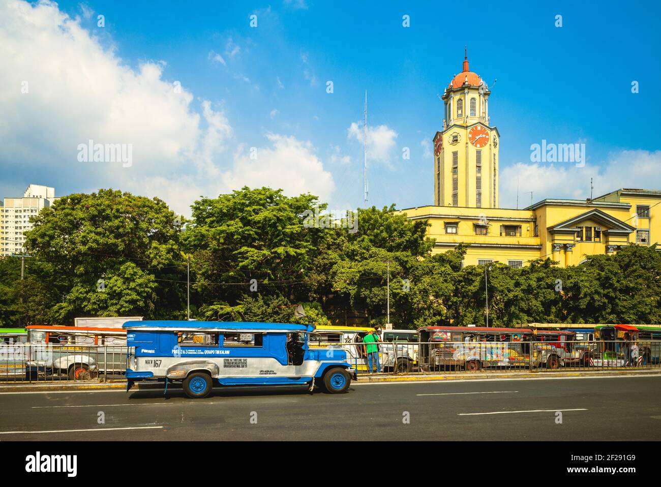 April 8, 2019: Clock tower of Manila City Hall with jeepney. The clock tower, in the historic center of Ermita, Manila, philippines, was designed by A Stock Photo