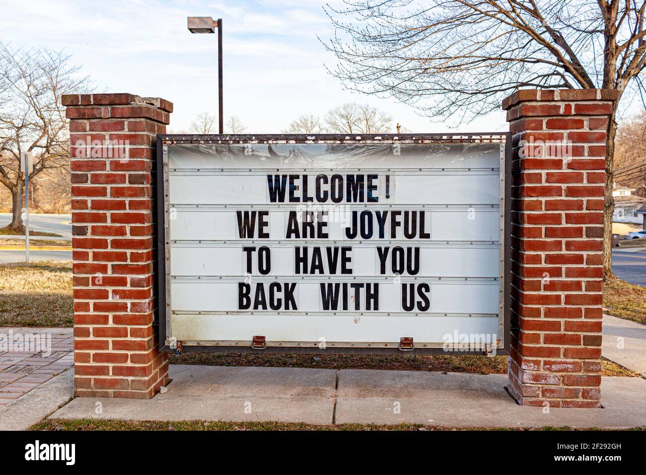 A large notice board in front of a public school in Maryland has a message to students who have been away due to COVID-19 pandemic. It reads welcome, Stock Photo