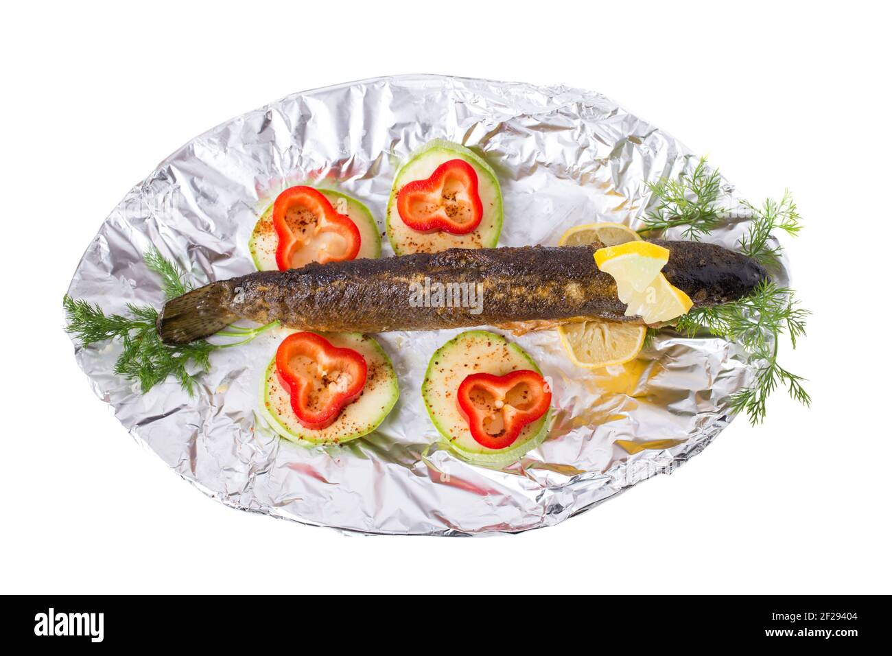 Delicious grilled trout with vegetables on kitchen silver foil
