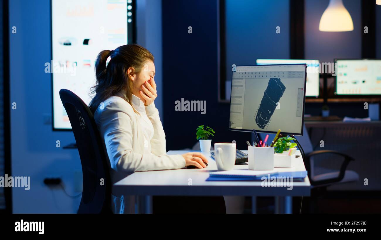 Tired designer engineer analizing new prototype of 3D model of the ...