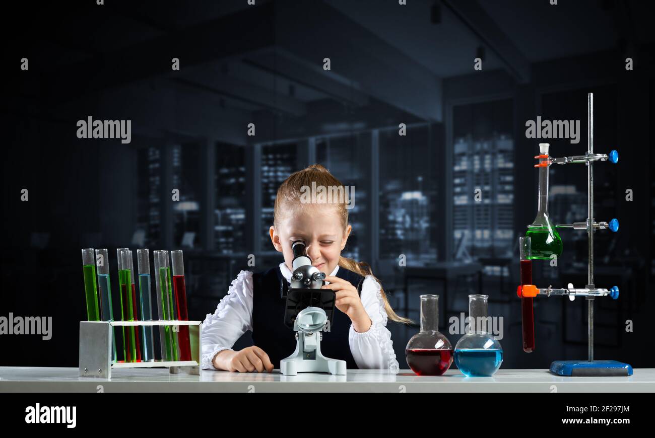 Little girl scientist looking through microscope Stock Photo - Alamy
