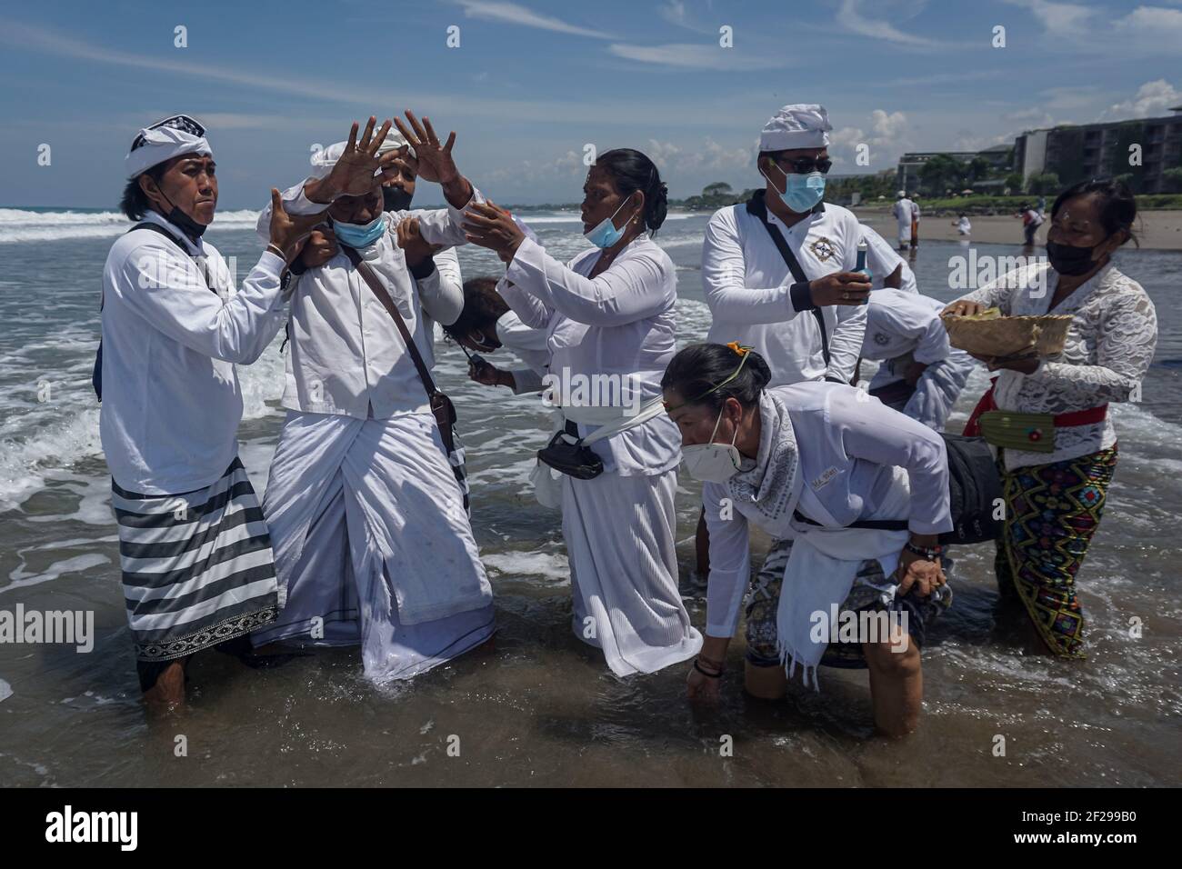 Badung, Bali, Indonesia. 10th Mar, 2021. A devotee seen as he trance during the event. Balinese Hindu to celebrate Melasti, a soul-cleansing ceremony at Petitenget Beach before Nyepi, the Day of Silence, holiday. Nyepi will be held on March 14, 2021, which marks New Year in Balinese calendar. By the Covid-19 outbreak, Melasti this year only limited for few selected people. In the normal condition there are thousands of them. (Credit Image: © Dicky BisinglasiZUMA Wire) Stock Photo