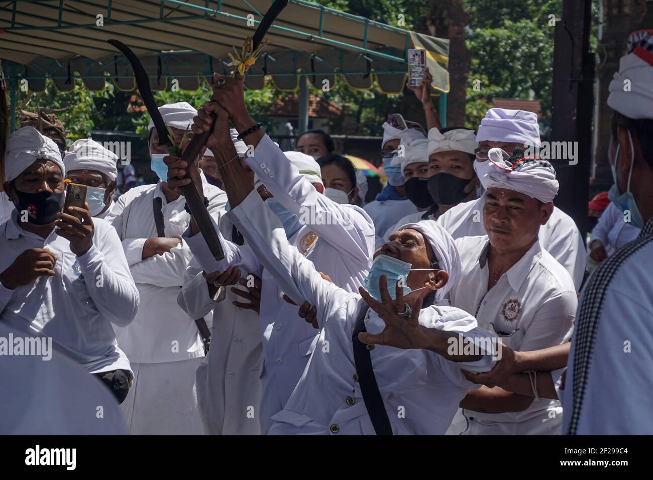 Badung, Bali, Indonesia. 10th Mar, 2021. A devotee seen as he trance during the event. Balinese Hindu to celebrate Melasti, a soul-cleansing ceremony at Petitenget Beach before Nyepi, the Day of Silence, holiday. Nyepi will be held on March 14, 2021, which marks New Year in Balinese calendar. By the Covid-19 outbreak, Melasti this year only limited for few selected people. In the normal condition there are thousands of them. (Credit Image: © Dicky BisinglasiZUMA Wire) Stock Photo