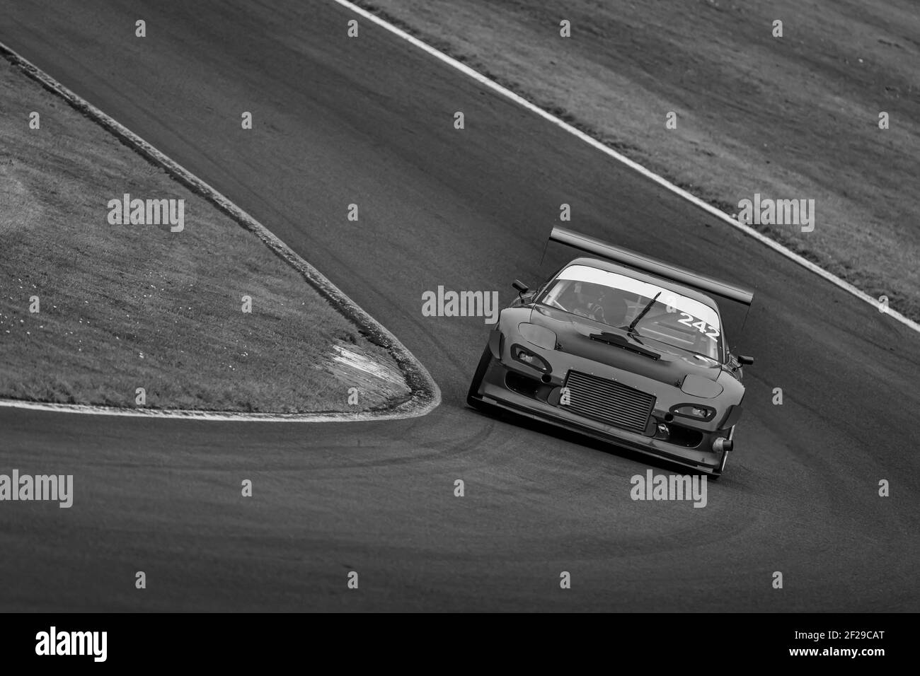 A shot of a racing car as it circuits a track. Stock Photo