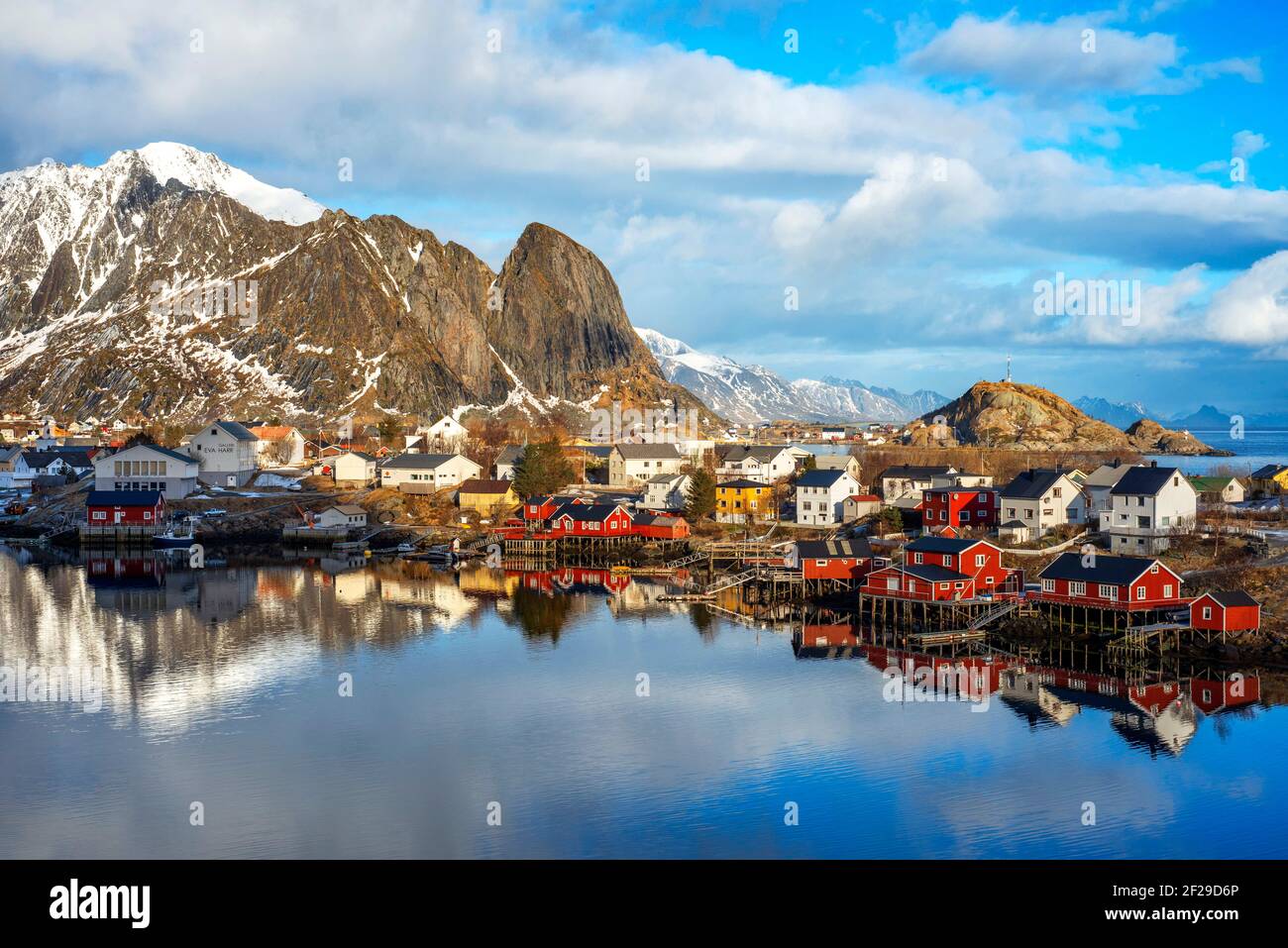 View across the natural fishing harbour to towering mountains above Reine, Moskenes, Moskenesøya Island, Lofoten Islands, Norway Stock Photo