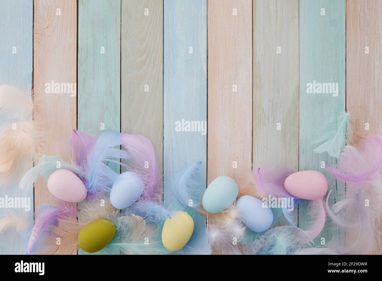 Happy easter concept. Frame with colorful Easter eggs and feathers on ...