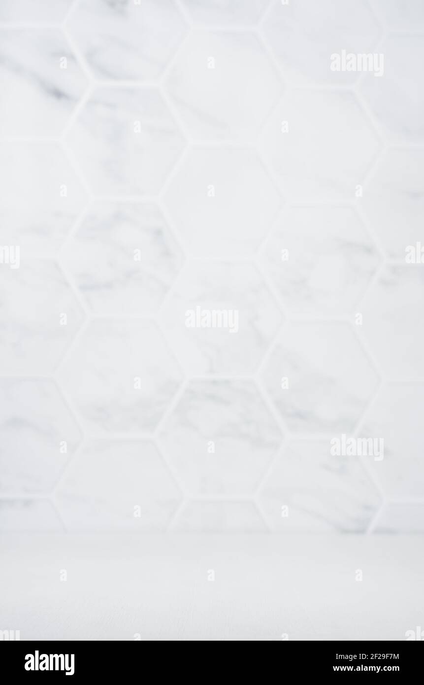 Light white grey marble hexagon tile wall unfocused with white wood