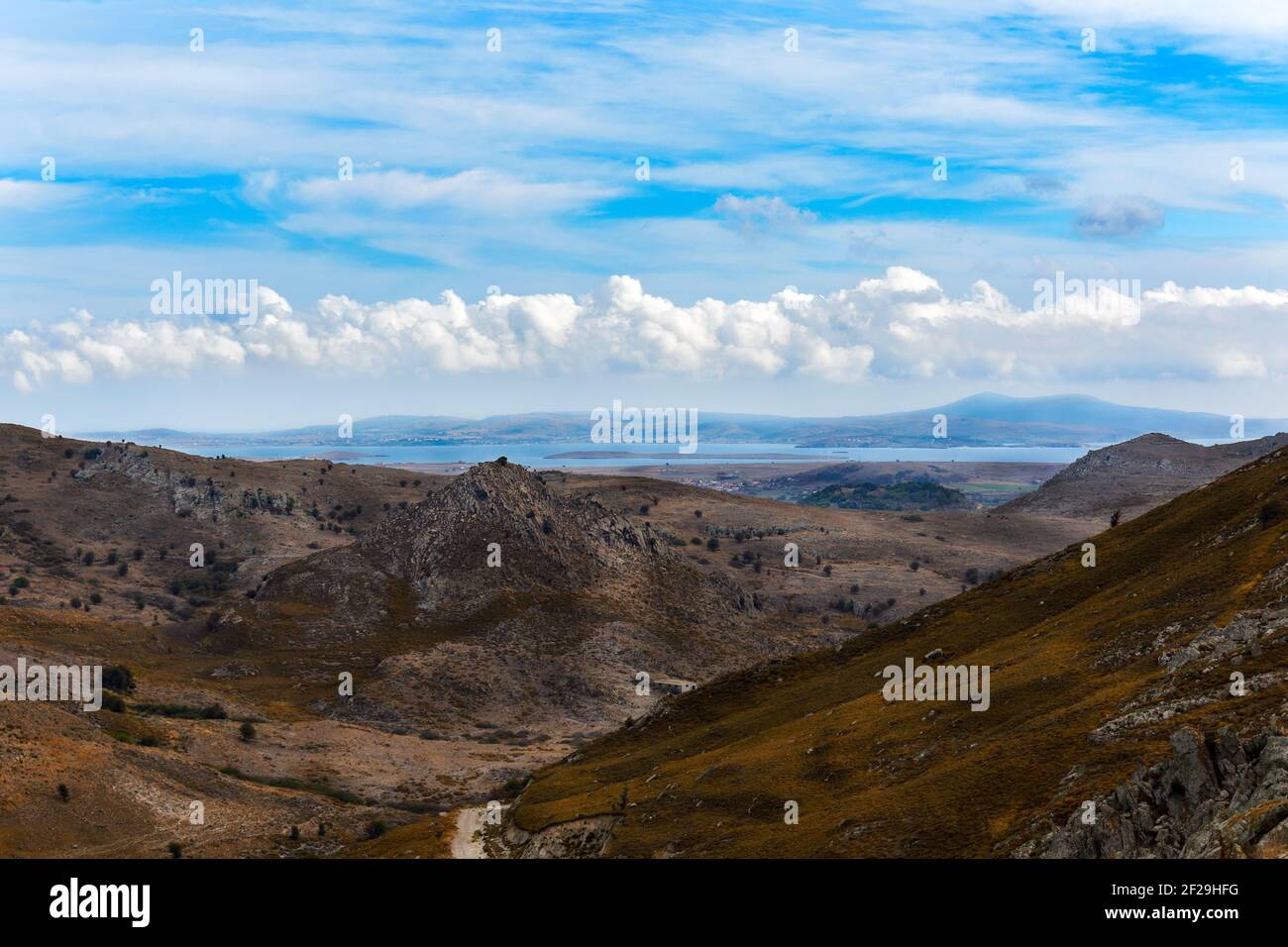 A mountain range with rocks and bushes against the backdrop of the sea and the bay of Moudros on the island of Lemnos in Greece. Stock Photo