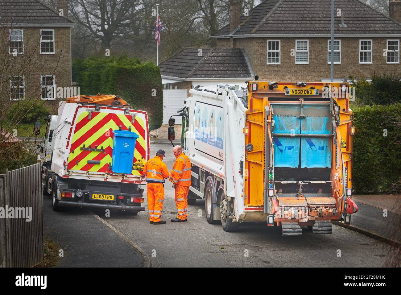 Bin collection workers next to a large recycling lorry and a smaller (food)  recycling vehicle belonging to Corby and Kettering Councils Stock Photo -  Alamy