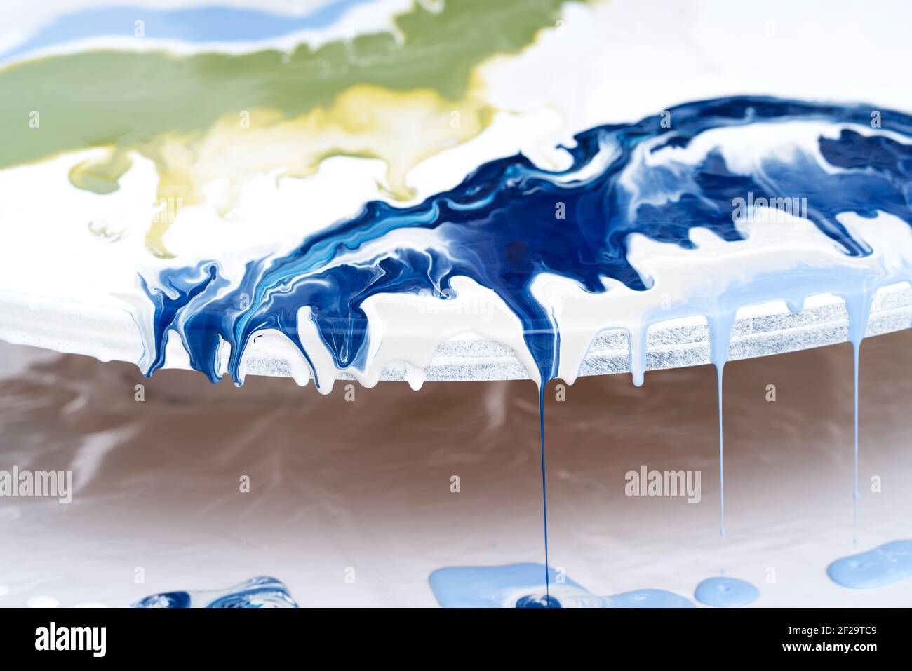 The process of creating a painting using fluid art technique. Stock Photo