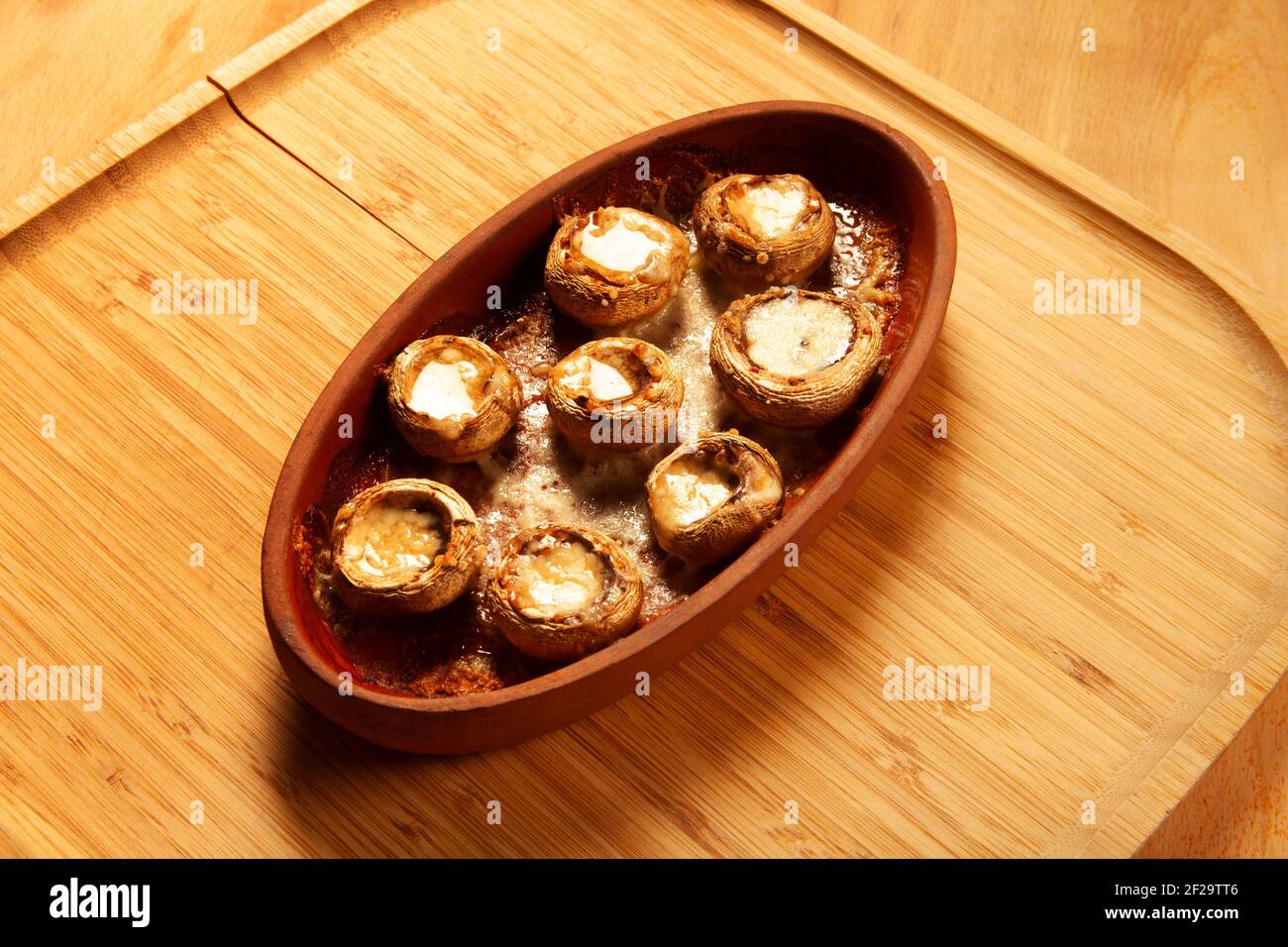 Baked white mushrooms in butter Stock Photo - Alamy