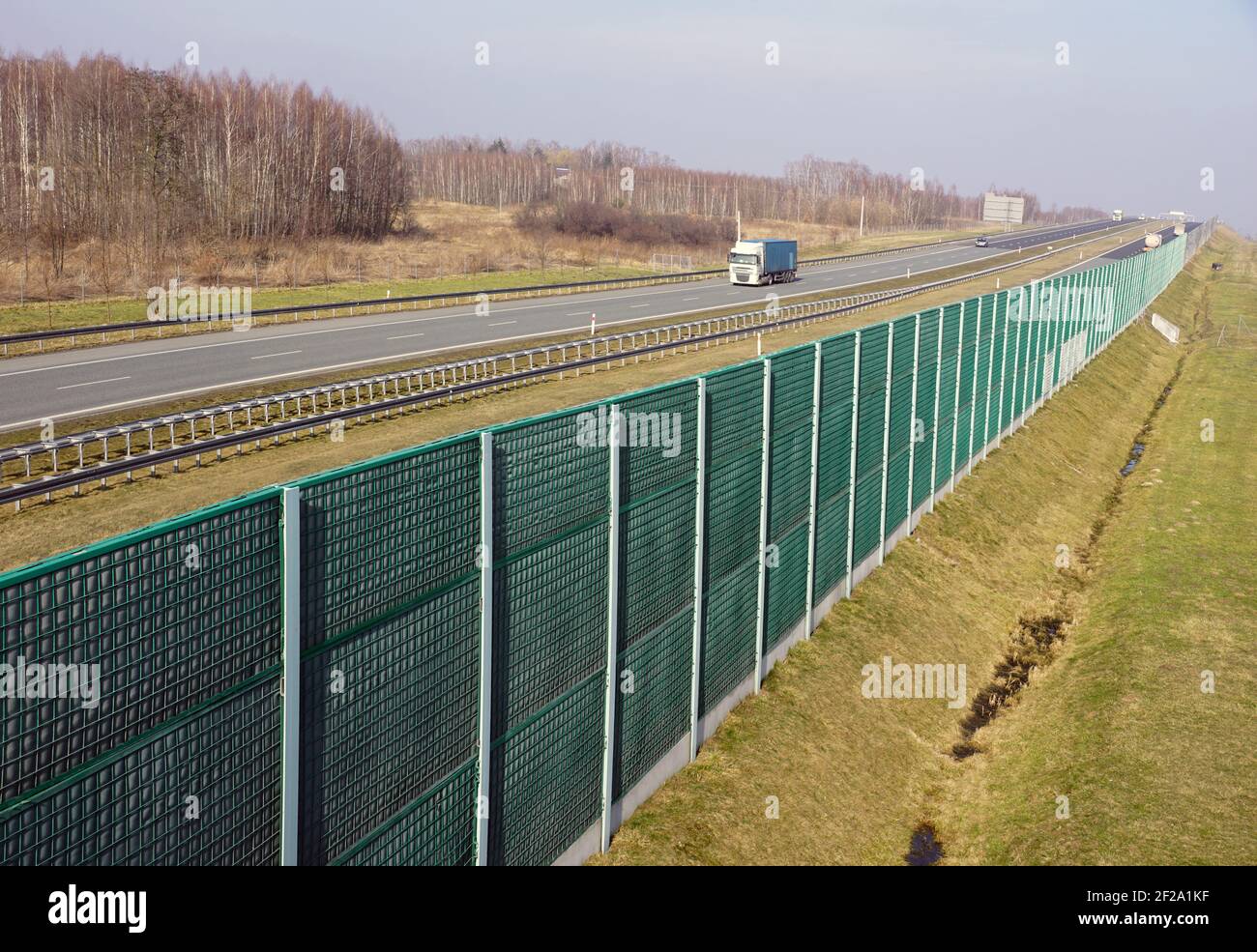 High soundabsorbing barriers separating the highway from the