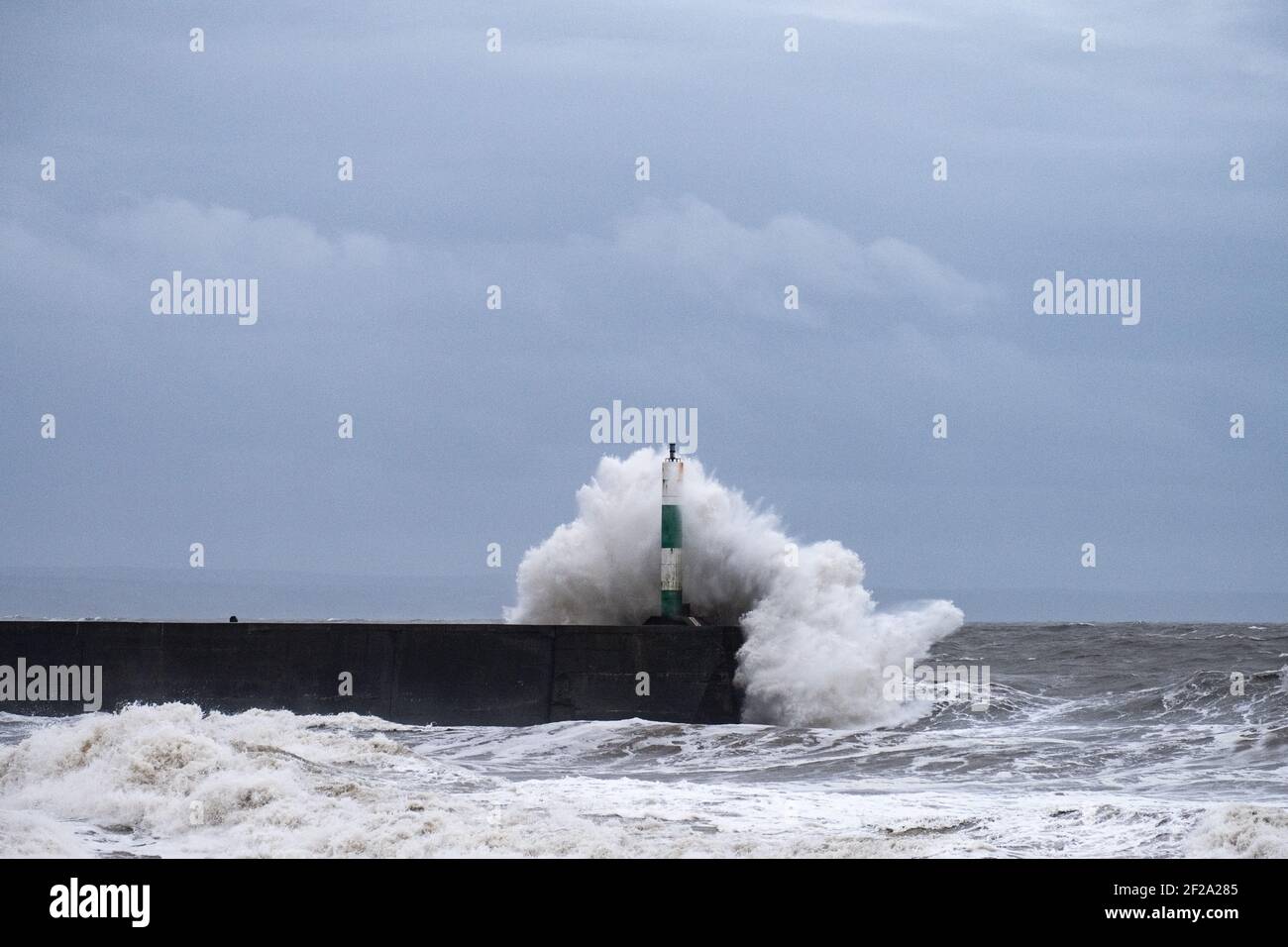 Aberystwyth, Ceredigion, Wales, UK. 11th March 2021 UK weather. A huge swell  and powerful winds create large waves that batter the coastal town of Aberystwyth. © Rhodri Jones/Alamy Live News Stock Photo