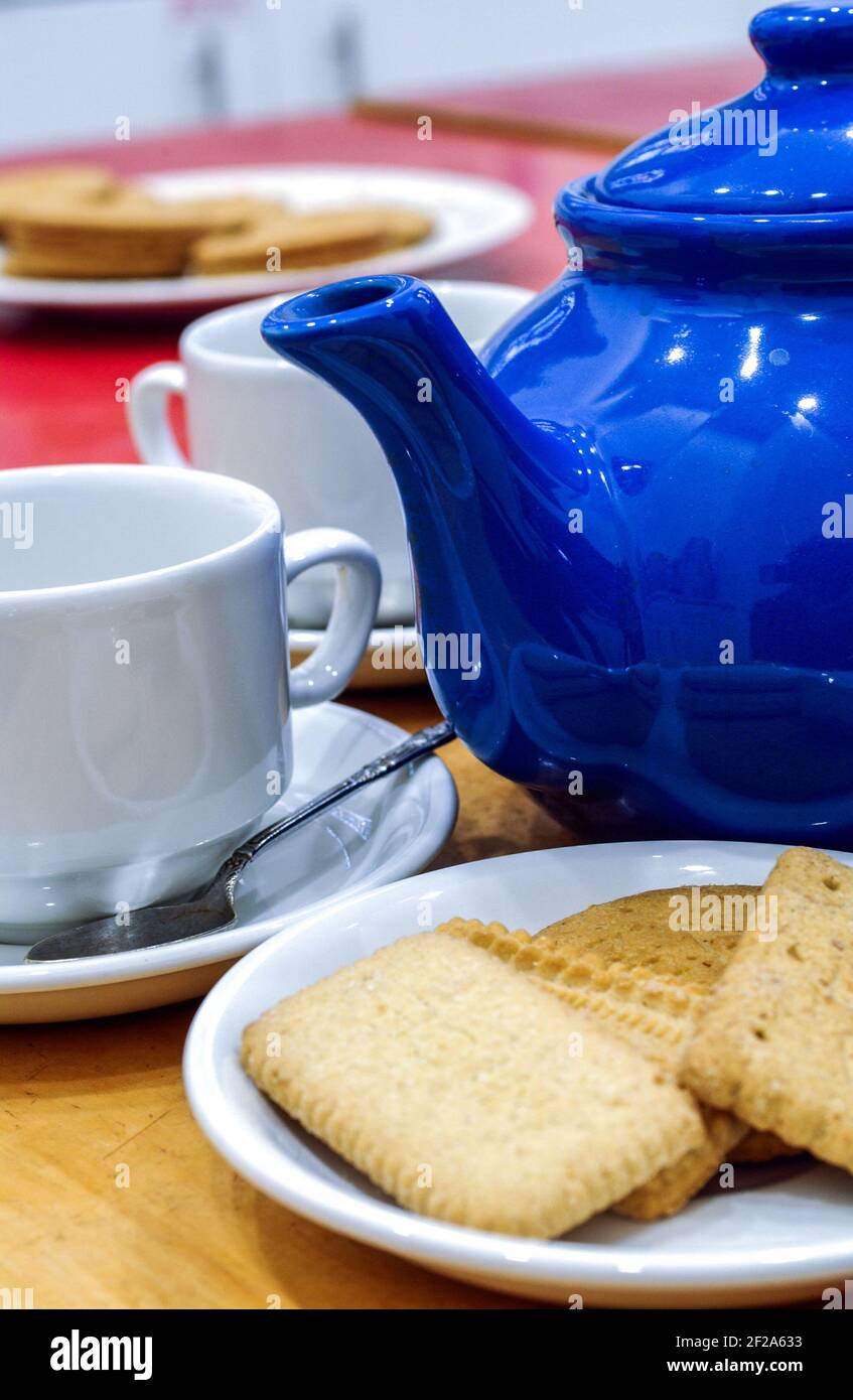 Close up of teapot, biscuits and cup for a traditional English teatime Stock Photo