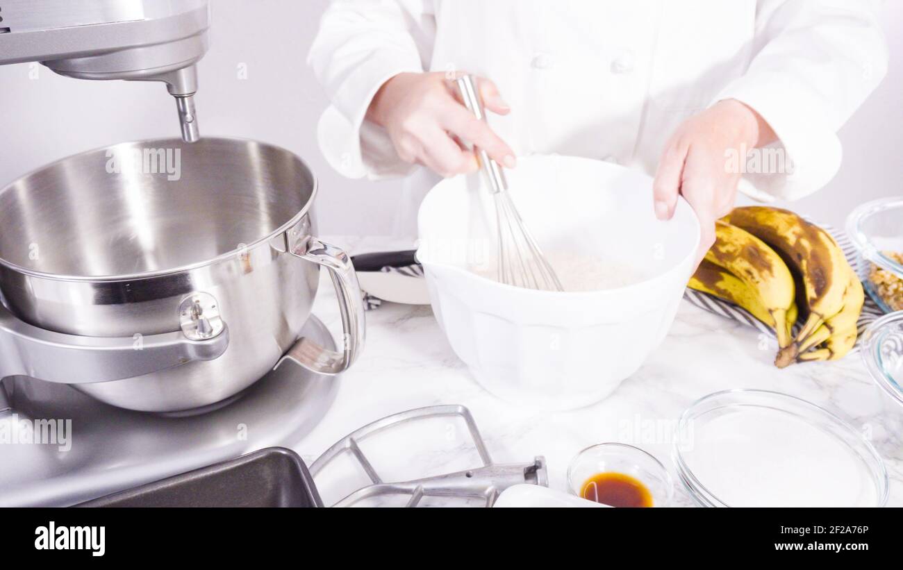 Step by step. Mixing ingredients together into a metal mixing bowl to ...