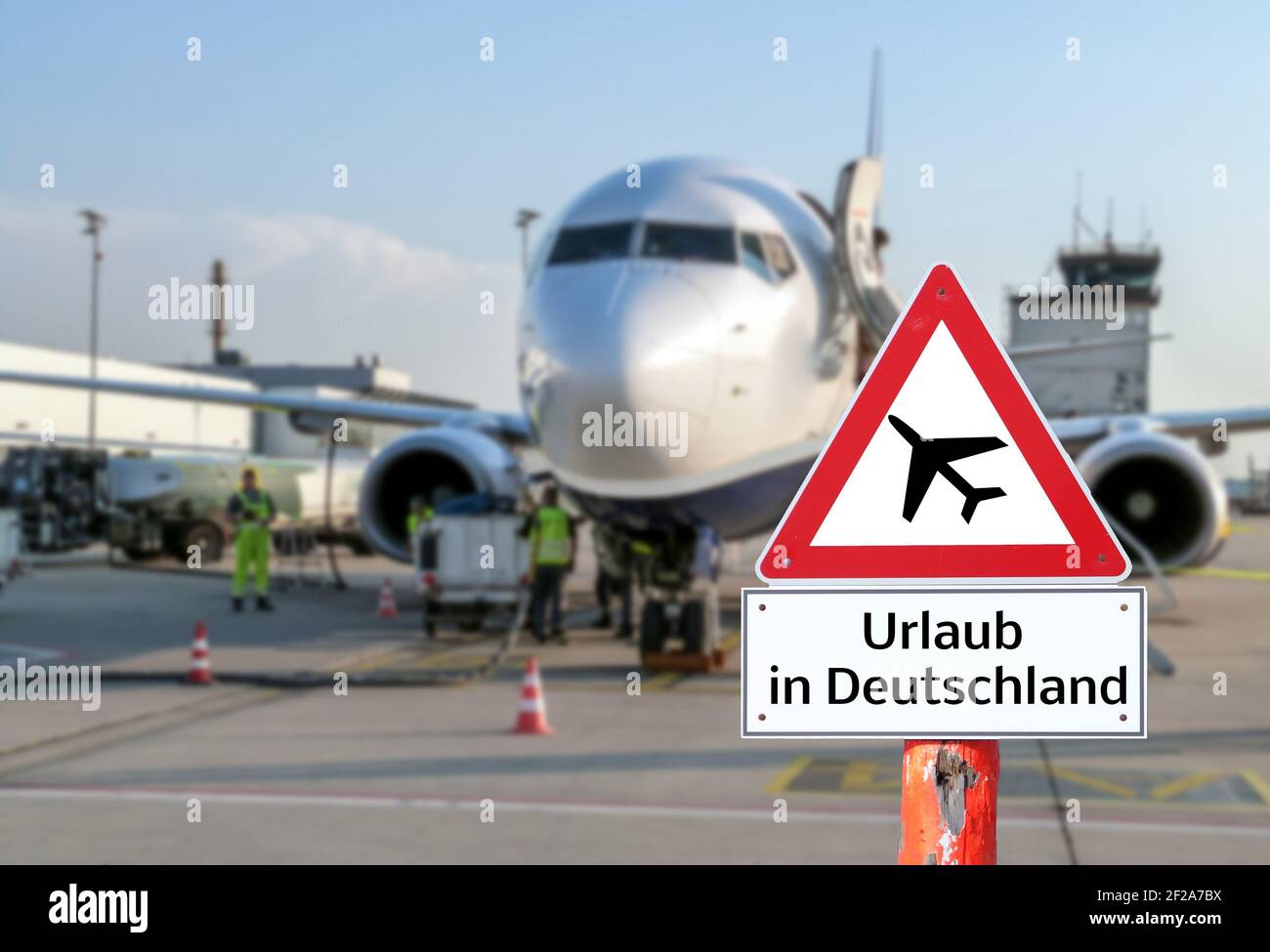 Warning sign Vacation in Germany airplane at the airport Stock Photo