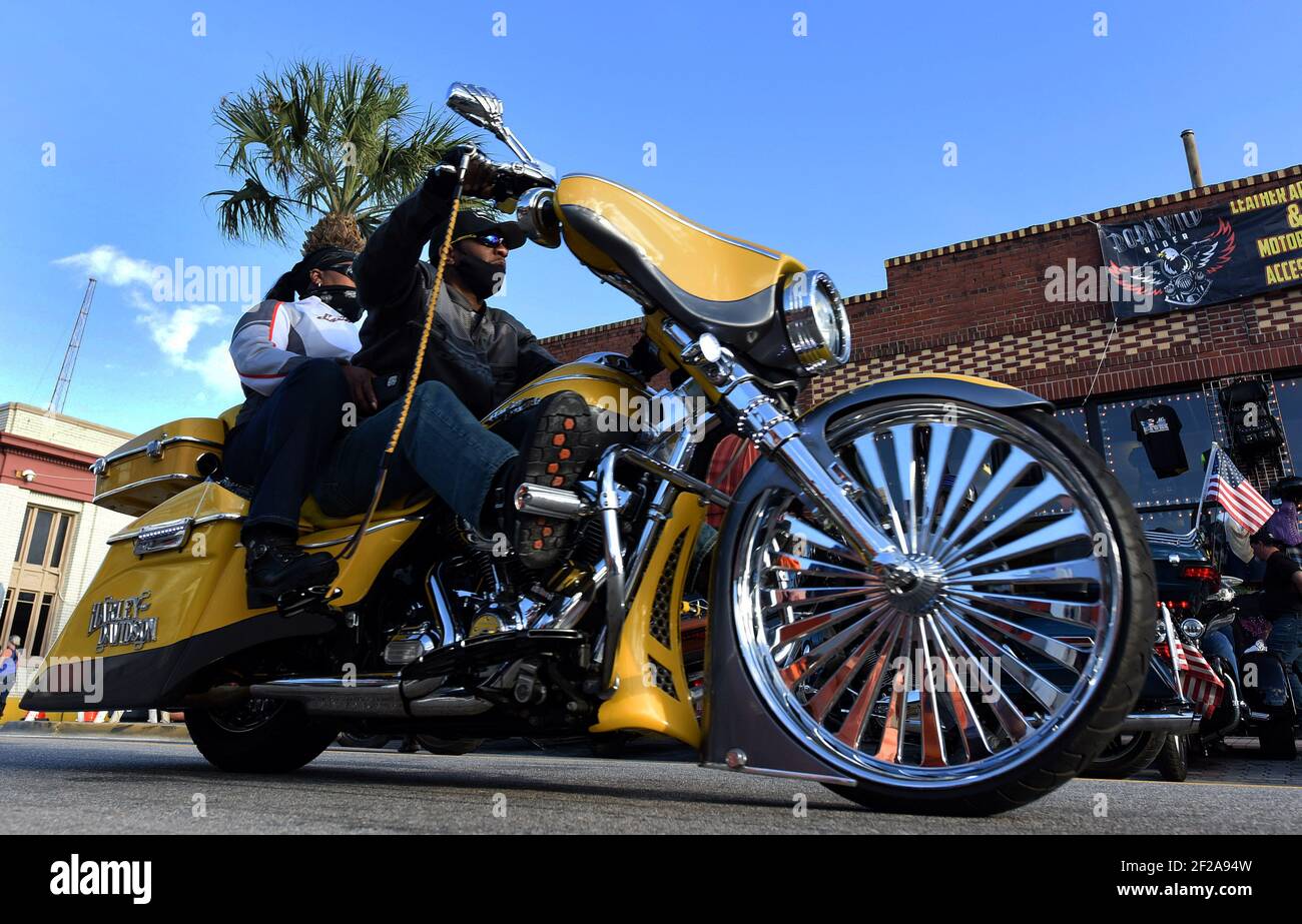 Daytona Beach, United States. 10th Mar, 2021. A motorcyclist rides down Main Street during the 80th year of Daytona Beach's annual Bike Week event. Few people were seen wearing face masks or practicing social distancing and some worry the gathering could become a superspreader event as the coronavirus pandemic continues. Credit: SOPA Images Limited/Alamy Live News Stock Photo