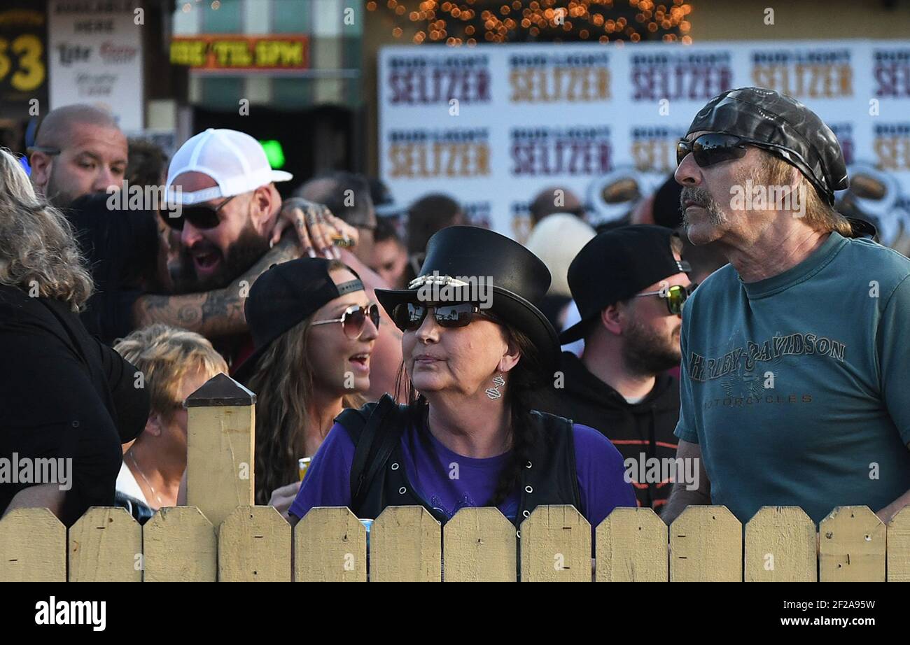Daytona Beach, United States. 10th Mar, 2021. People gather at the Full Moon Saloon on Main Street during the 80th year of Daytona Beach's annual Bike Week event. Few people were seen wearing face masks or practicing social distancing and some worry the gathering could become a superspreader event as the coronavirus pandemic continues. Credit: SOPA Images Limited/Alamy Live News Stock Photo