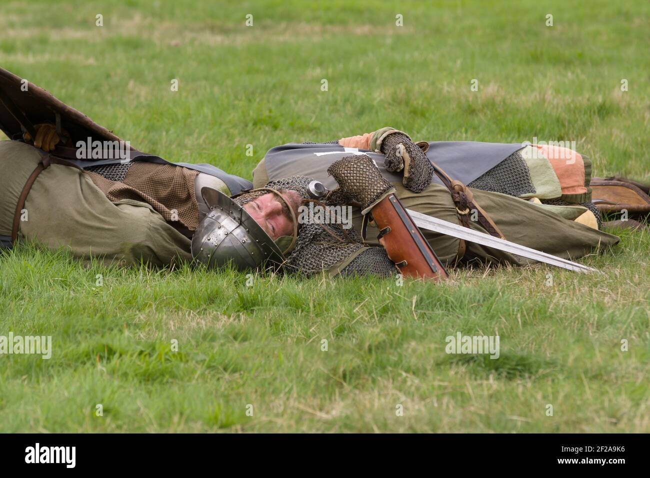 Medieval battle with an actor playing the role of a casualty during a re-enactment of battle of Crogen 1165 in Chirk North Wales Stock Photo