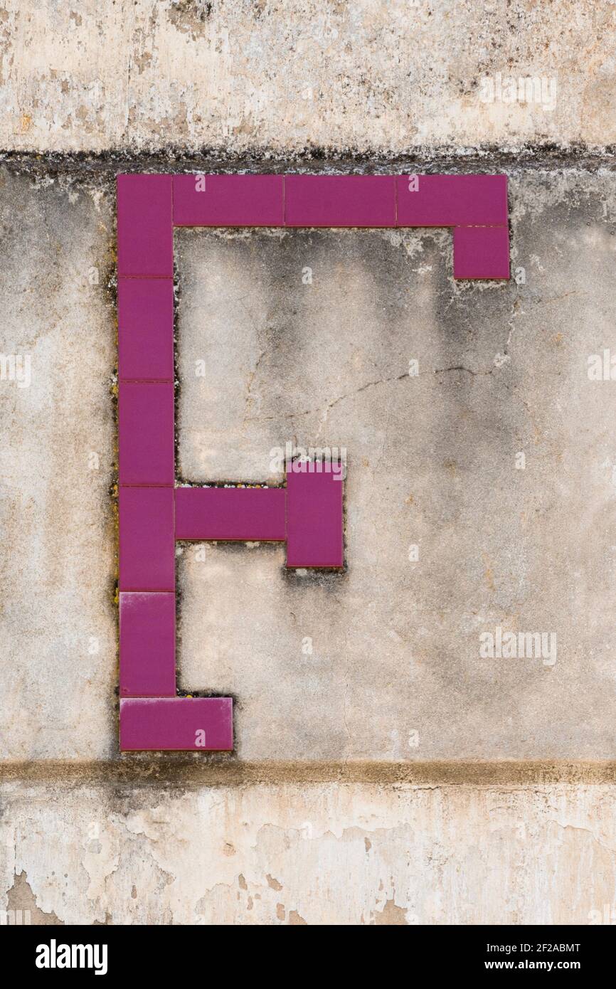Letter F composed of wine red tiles Stock Photo