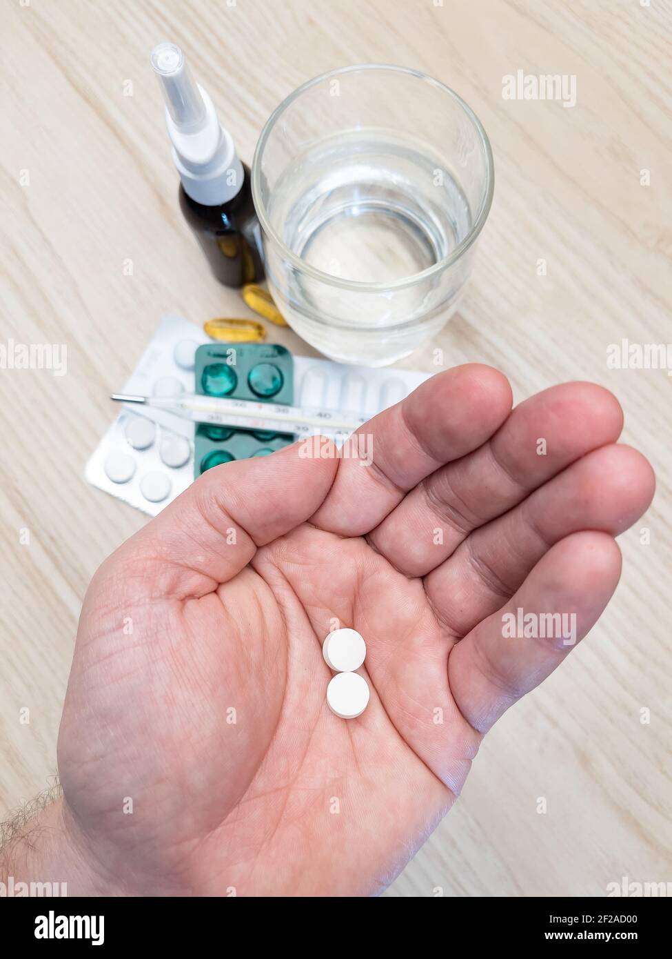 Man hand holding white pills. Top down view. Medical and health concepts. Stock Photo