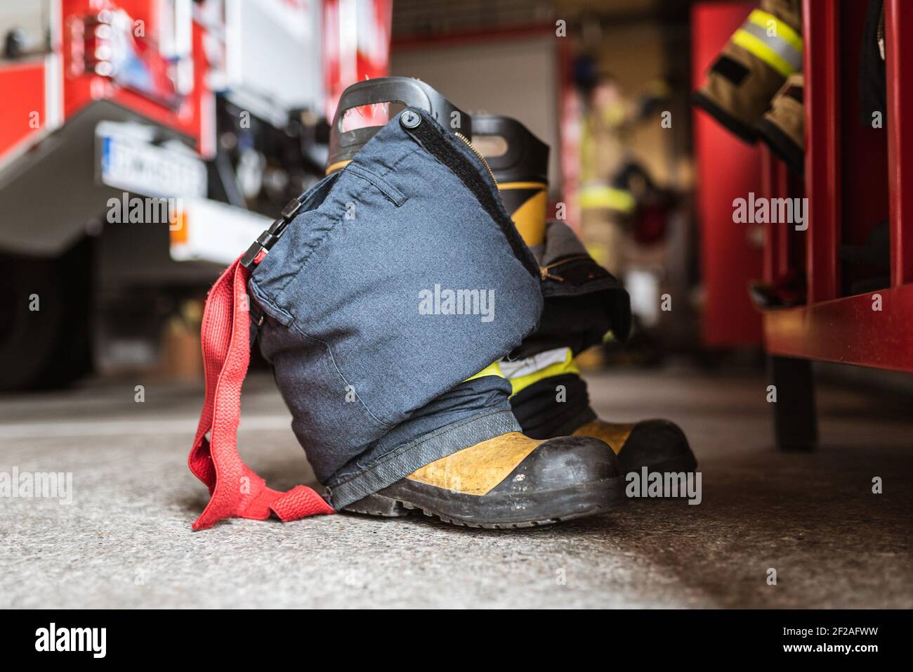 Firefighter's shoes and pants and a wardrobe cabinet, fire truck and ...