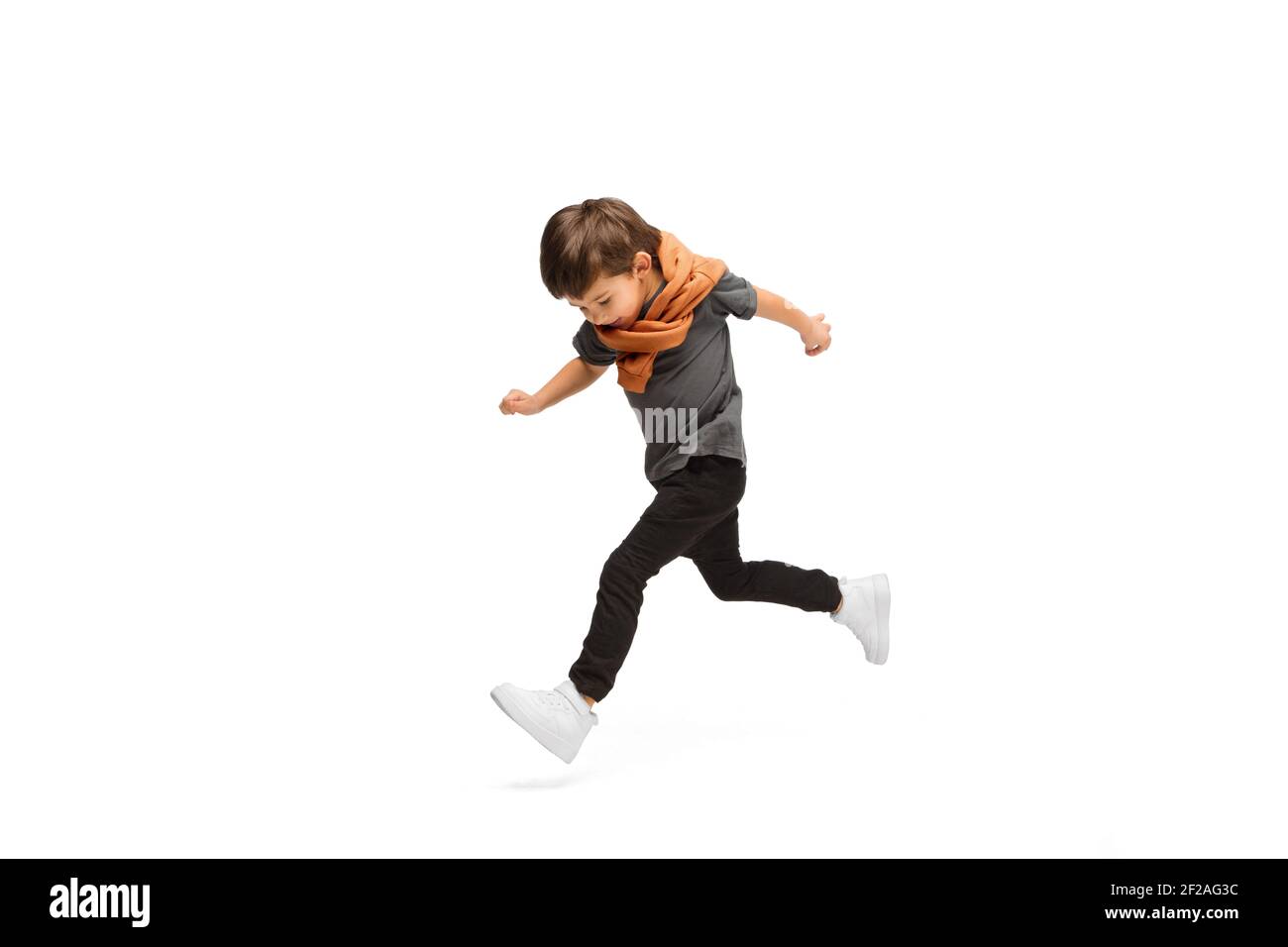 Jumping, running. Happy, smiley little caucasian boy isolated on white