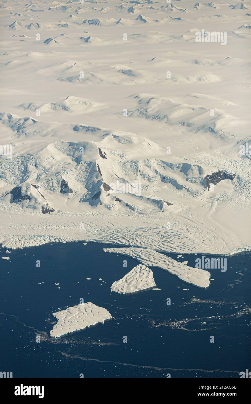 An aerial view of the snowy ice-covered landmass in Antarctica Stock Photo
