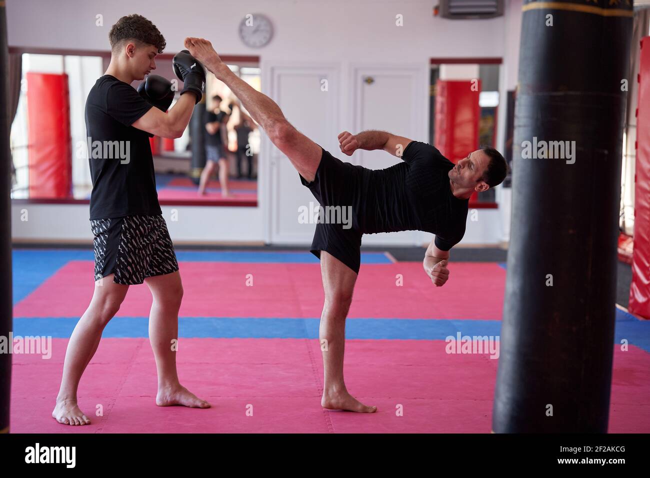 Young kickboxer sparring with his partner or coach in the gym Stock Photo -  Alamy