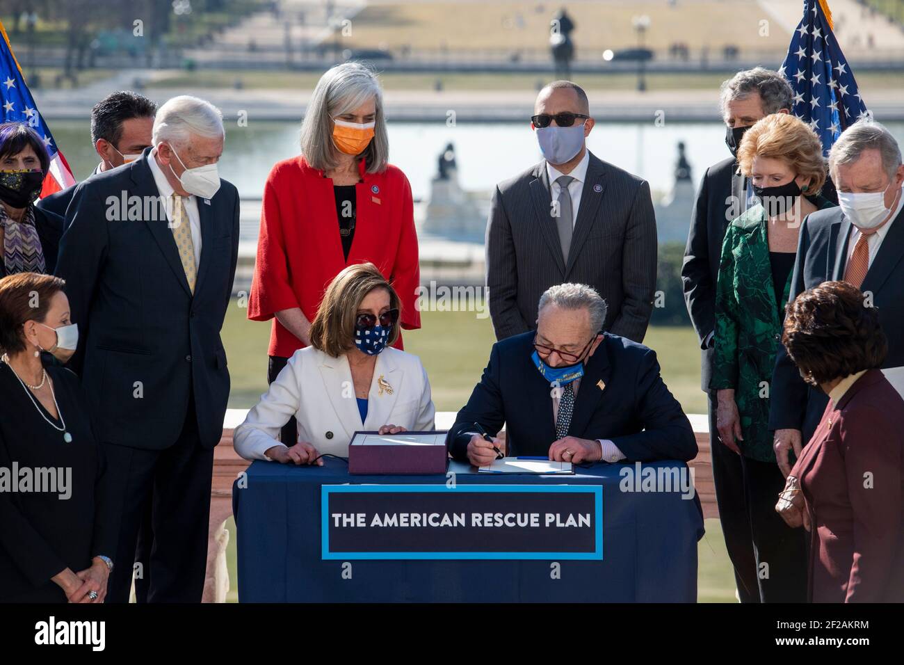 CAPTION CORRECTION: Speaker of the United States House of Representatives Nancy Pelosi (Democrat of California) and United States Senate Majority Leader Chuck Schumer (Democrat of New York) sign the American Rescue Plan Act of 2021, during an enrollment ceremony, on the West Terrace of the U.S. Capitol in Washington, DC, Wednesday, March 10, 2021. Credit: Rod Lamkey / CNP/Sipa USA Stock Photo