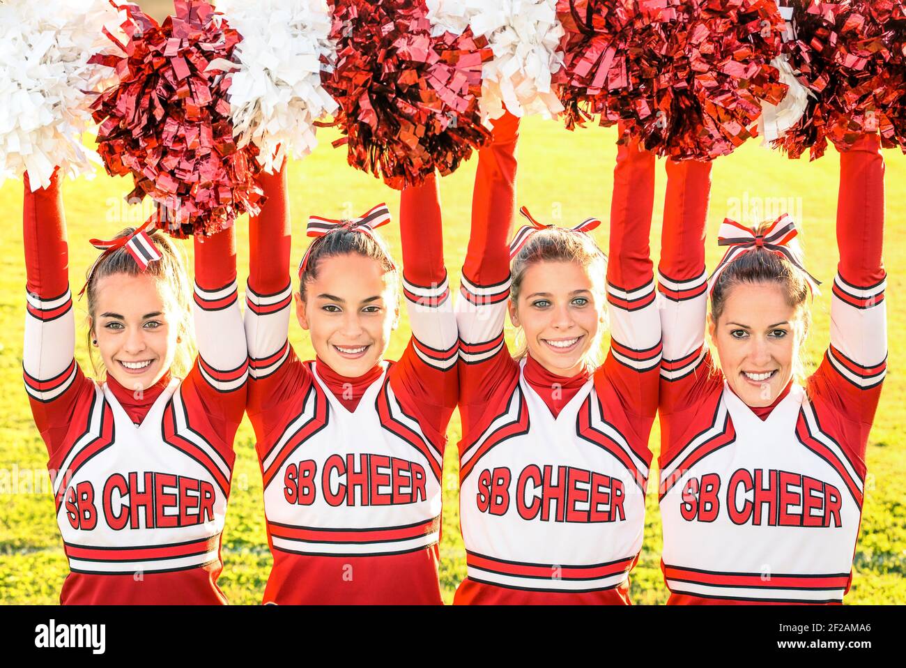 Cheerleaders team in action at high school playground Stock Photo