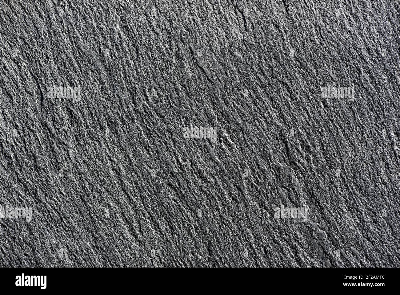 Black slate stone texture, selective focus. Stock Photo