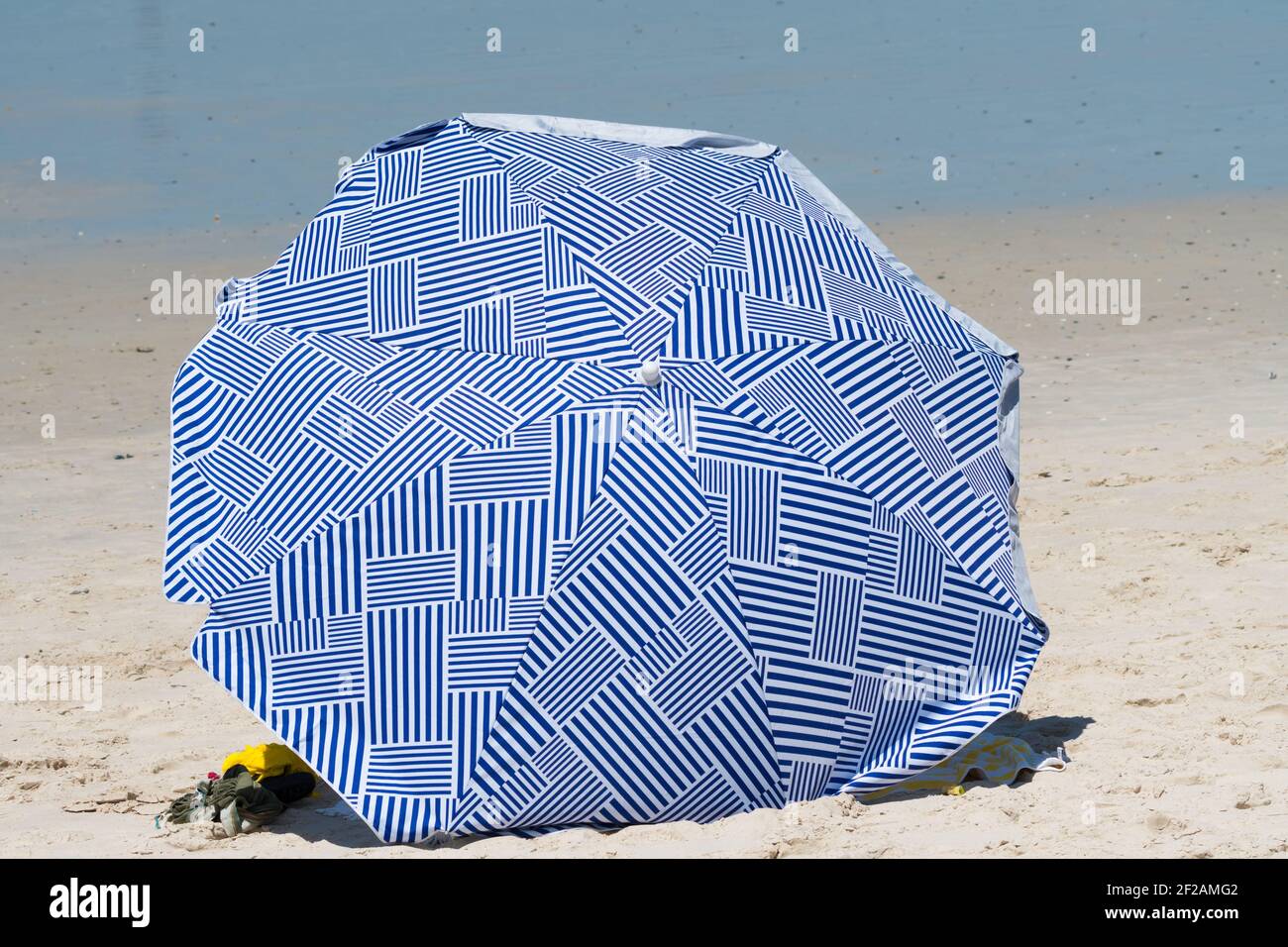 beach umbrella open on white sand concept Summer holiday or vacation with sun sea and sand Stock Photo