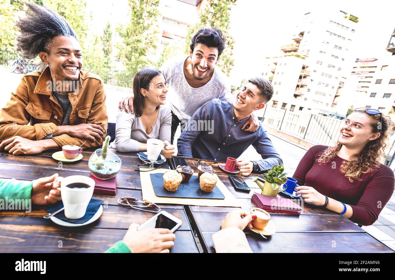People group drinking cappuccino at coffee bar restaurant - Friends talking and having fun together at outdoors cafeteria - Life style concept Stock Photo